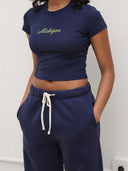 close up of women wearing michigan script baby tee by one dna