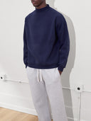 male model wears mock neck sweatshirt in navy one dna clothing