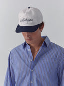 model wears michigan script hat in white and navy one dna ann arbor
